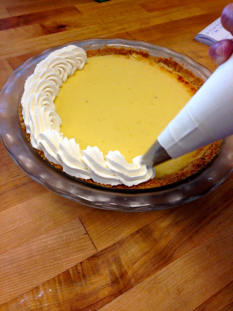 Finish the easy key lime pie recipe by decorating the top with fresh whipped cream. #Easy #KeyLimePie #Recipe