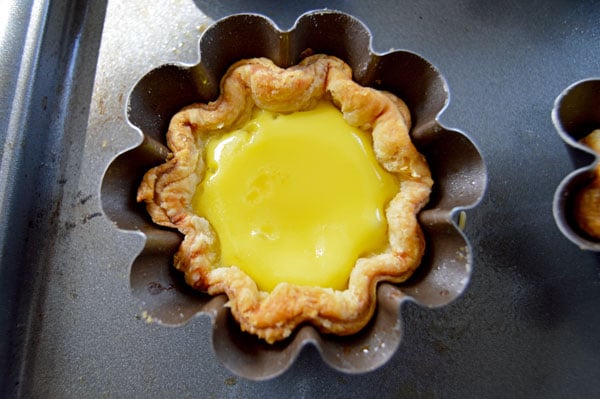 Hong Kong Egg Tarts - a popular pastry in China, Taiwan, Macau, Hong Kong and at dim sum restaurants. An easy and delicious taste of Asia! | www.thehungrytravelerblog.com