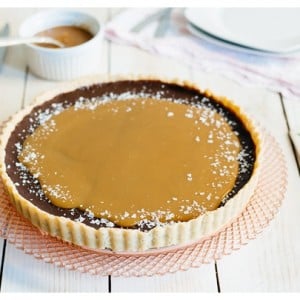 The French Salted Caramel Chocolate Tart on a decorative cake stand