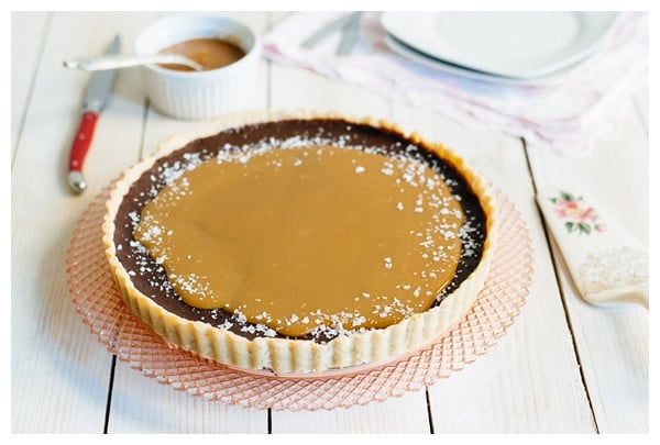 The French Salted Caramel Chocolate Tart on a decorative cake stand