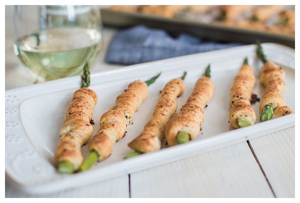 Asparagus Bundles -- Asparagus stalks wrapped in prosciutto, filled with garlic-herb cheese, rolled in crescent dough, topped with Parmesan and baked. A great appetizer, small bite or side dish!